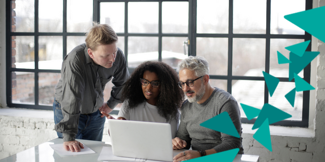 Three people gathered around laptop