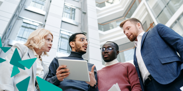 Group of four people looking at tablet